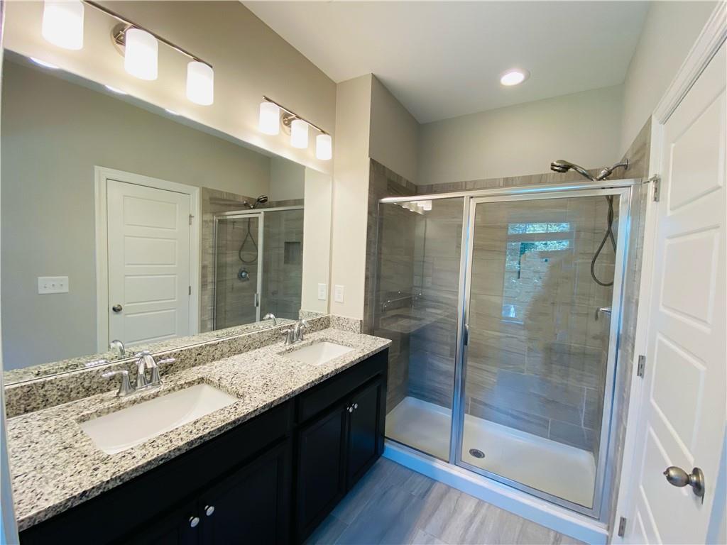 1815 Hislop Lane, Unit 8 Atlanta, GA 30345 - Photo 18 of 38 a bathroom with a granite countertop sink mirror and double