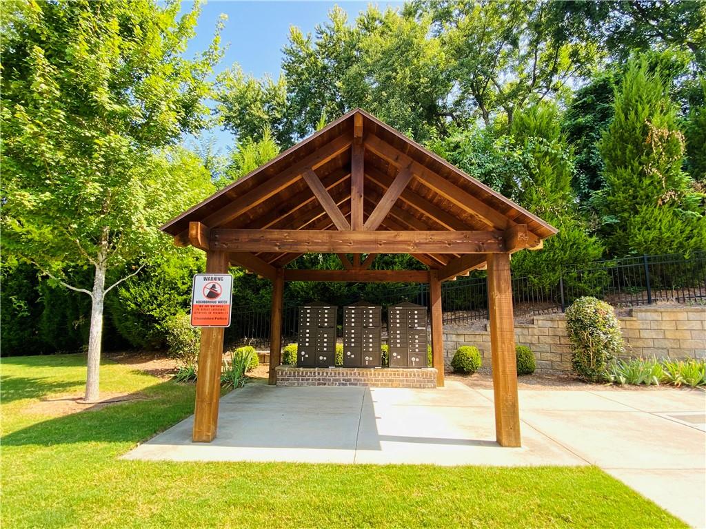 1815 Hislop Lane, Unit 8 Atlanta, GA 30345 - Photo 36 of 38 a patio with a table and chairs under an umbrella