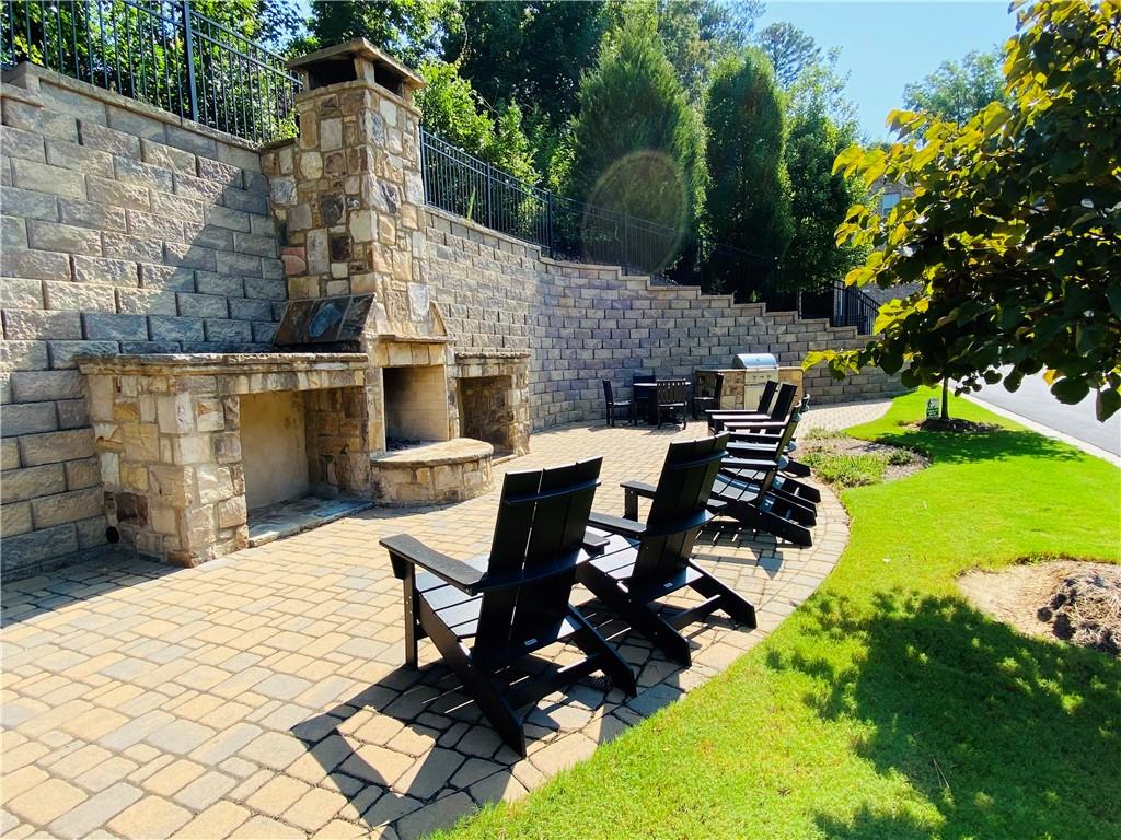 1815 Hislop Lane, Unit 8 Atlanta, GA 30345 - Photo 37 of 38 a view of a patio with table and chairs with wooden fence and plants