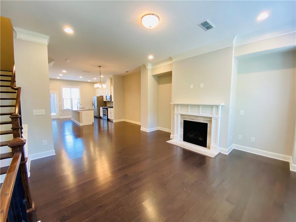 1815 Hislop Lane, Unit 8 Atlanta, GA 30345 - Photo 4 of 38 a view of an empty room with wooden floor and a fireplace