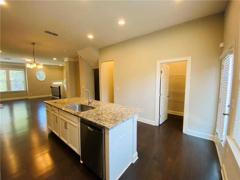 1815 Hislop Lane, Unit 8 Atlanta, GA 30345 - Photo 10 of 38 a kitchen with a stove and wooden floor