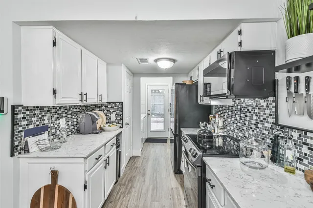 a kitchen with a sink stove and refrigerator