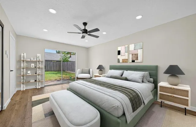 a bedroom with a bed a couch and a chandelier