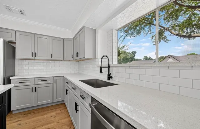 a kitchen with a sink and cabinets