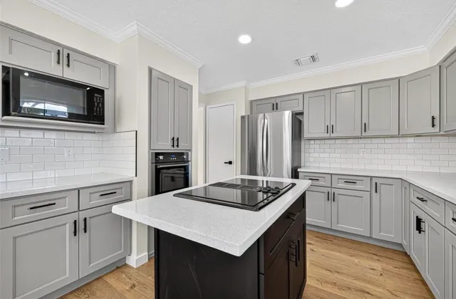 a kitchen with a sink stove and refrigerator