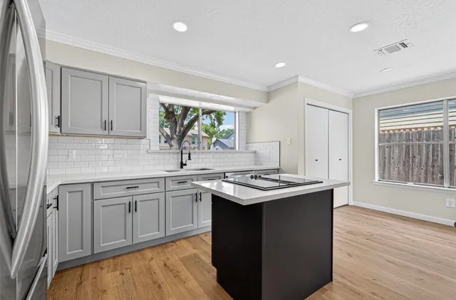 a kitchen with a sink stove and cabinets