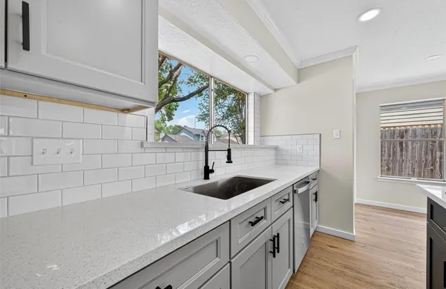 a view of a sink a counter space and wooden floor