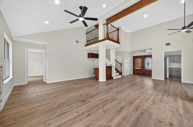 a view of empty room with wooden floor and fireplace
