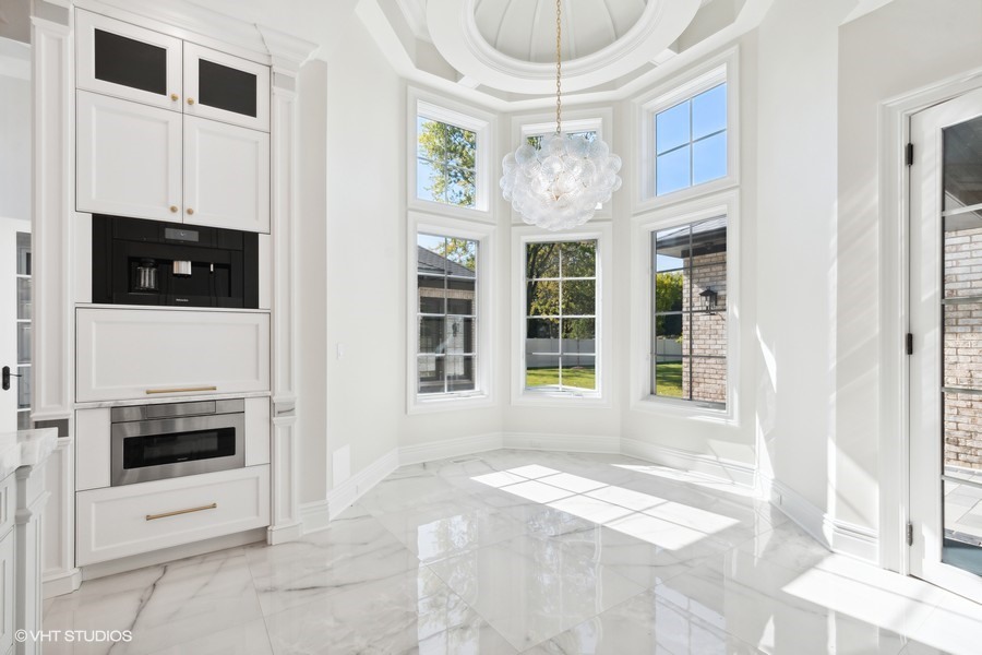 502 Greenwood Road Northbrook, IL 60062 - Photo 20 of 60 a view of an empty room with a window and kitchen view