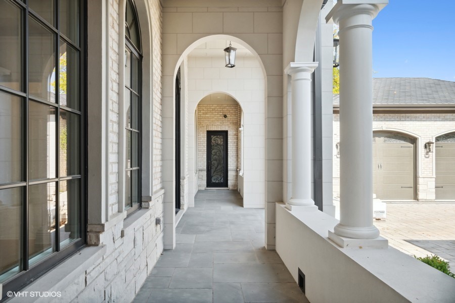 502 Greenwood Road Northbrook, IL 60062 - Photo 2 of 60 a view of a hallway with entryway wooden floor and front door