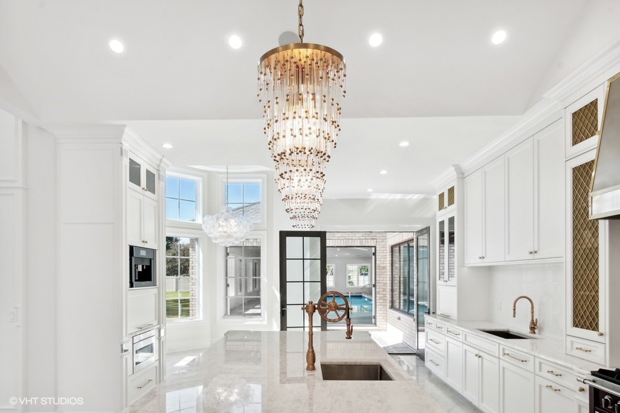 502 Greenwood Road Northbrook, IL 60062 - Photo 23 of 60 a room with stainless steel appliances lots of white furniture a chandelier and a window