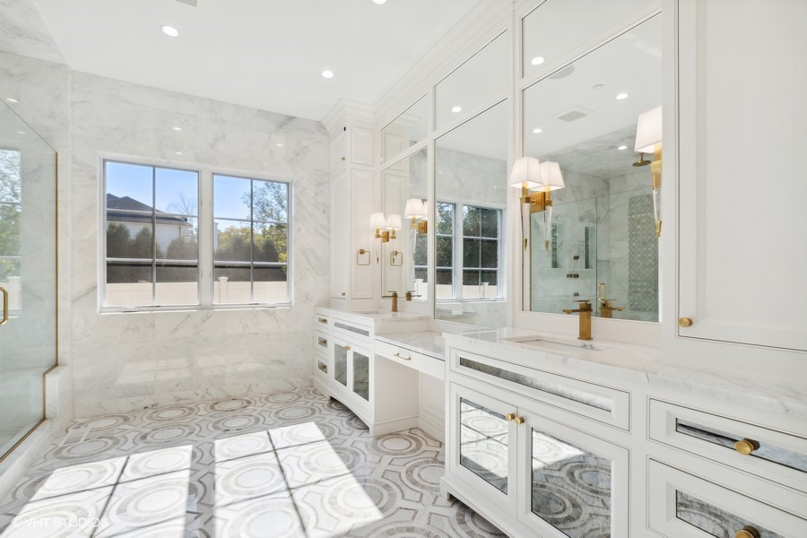 502 Greenwood Road Northbrook, IL 60062 - Photo 36 of 60 a bathroom with a sink a large mirror and a shower
