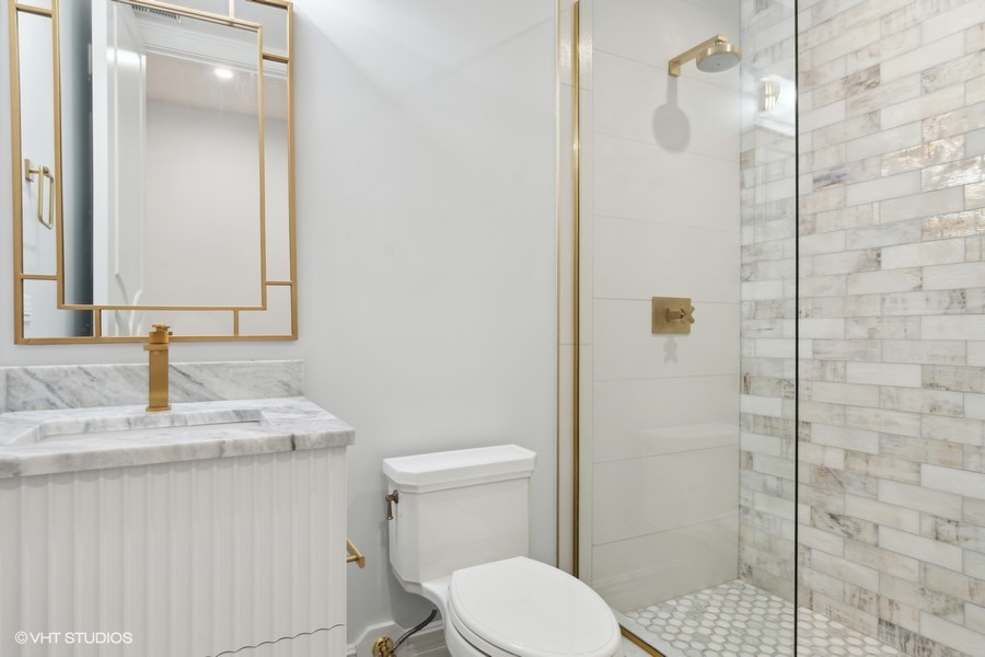 502 Greenwood Road Northbrook, IL 60062 - Photo 51 of 60 a bathroom with a granite countertop sink a toilet and shower