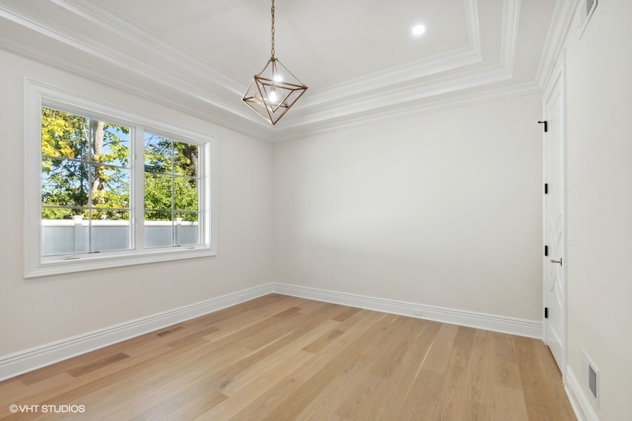 502 Greenwood Road Northbrook, IL 60062 - Photo 52 of 60 a view of empty room with wooden floor and fan