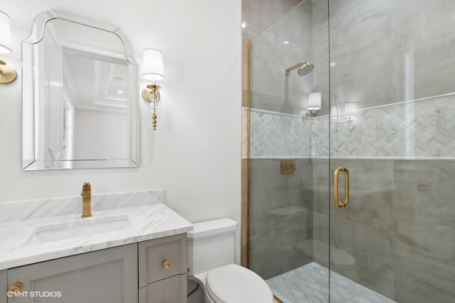 502 Greenwood Road Northbrook, IL 60062 - Photo 53 of 60 a bathroom with a granite countertop sink toilet a mirror and shower