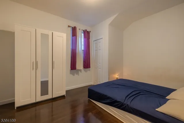 a room with a wooden floor and a window