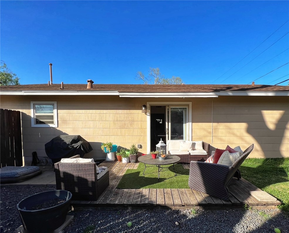 1807 Barbara Street Austin, TX 78757 - Photo 4 of 25 a view of a patio with couches table and chairs under an umbrella with a barbeque grill and couches
