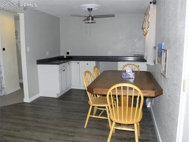 a view of a table and chairs in wooden floor