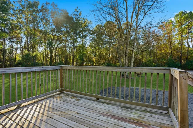 a view of deck with a large trees