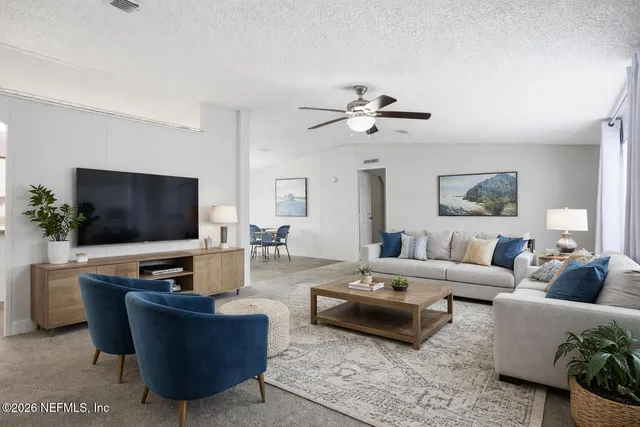 a living room with furniture and a flat screen tv