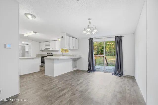 a kitchen with stainless steel appliances a sink stove and cabinets