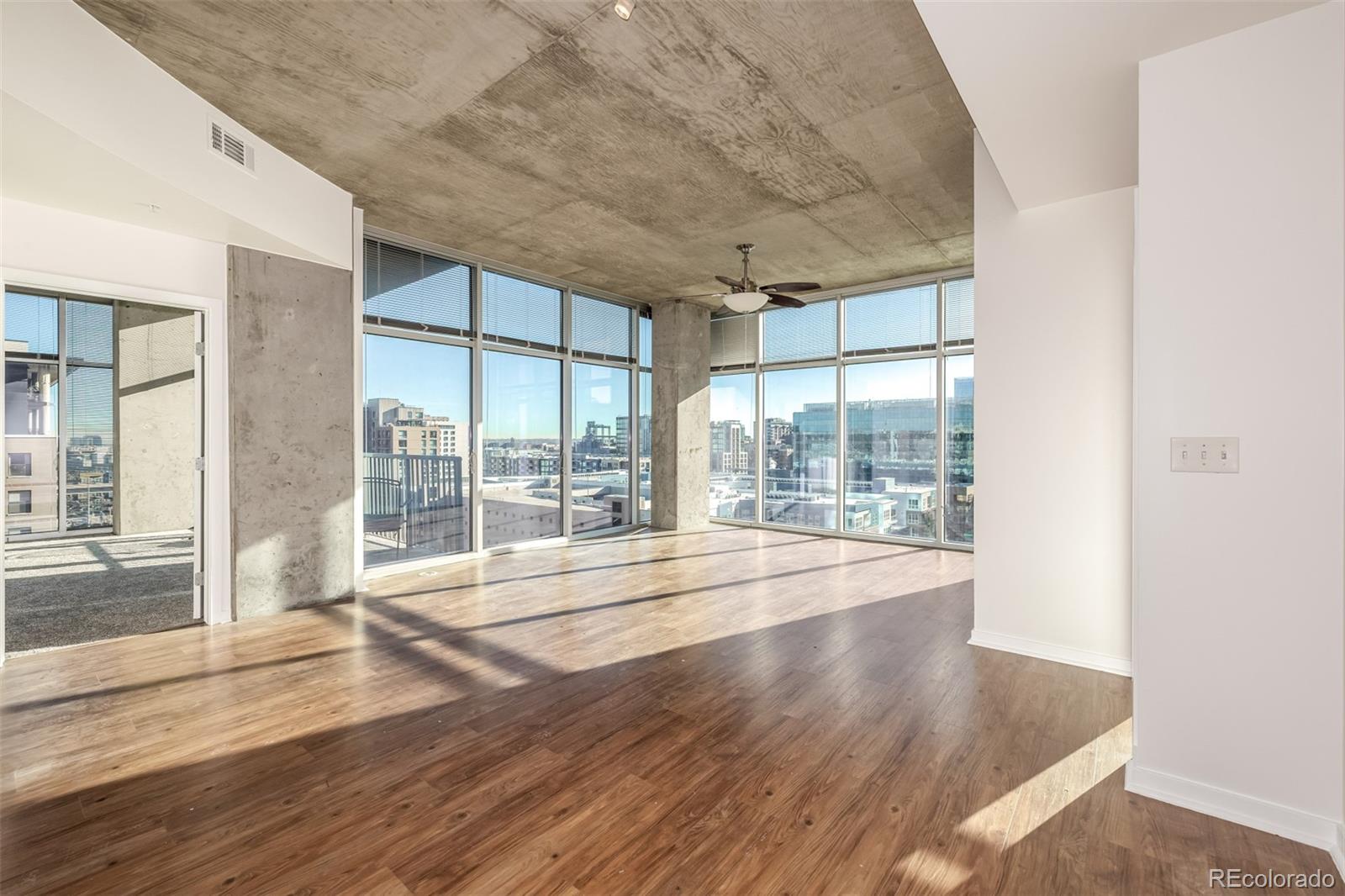 1700 Bassett Street, Unit 1012 Denver, CO 80202 - Photo 13 of 48 a view of an empty room with wooden floor and a window