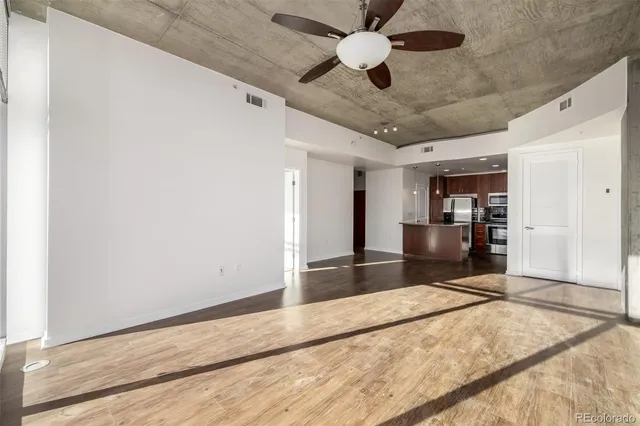 a kitchen with granite countertop a refrigerator and a sink