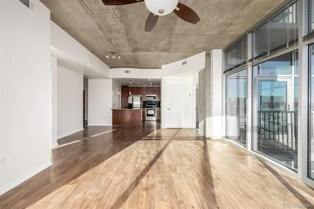 a view of a kitchen with a sink and a refrigerator