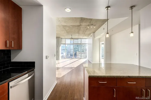 a view of a kitchen with a sink and wooden floor