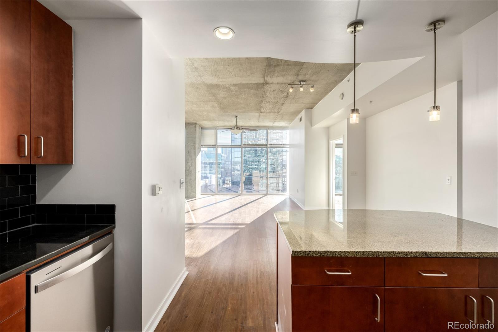 1700 Bassett Street, Unit 1012 Denver, CO 80202 - Photo 20 of 48 a view of a kitchen with a sink and wooden floor