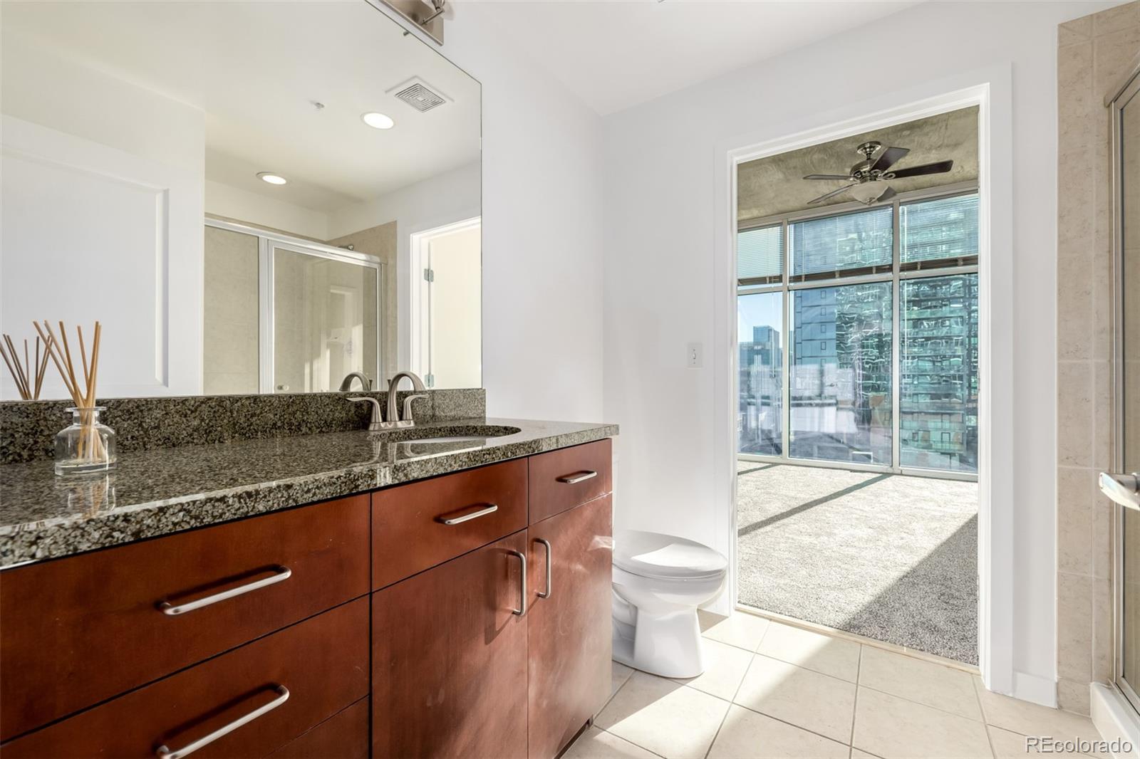 1700 Bassett Street, Unit 1012 Denver, CO 80202 - Photo 22 of 48 a spacious bathroom with a granite countertop sink toilet and shower