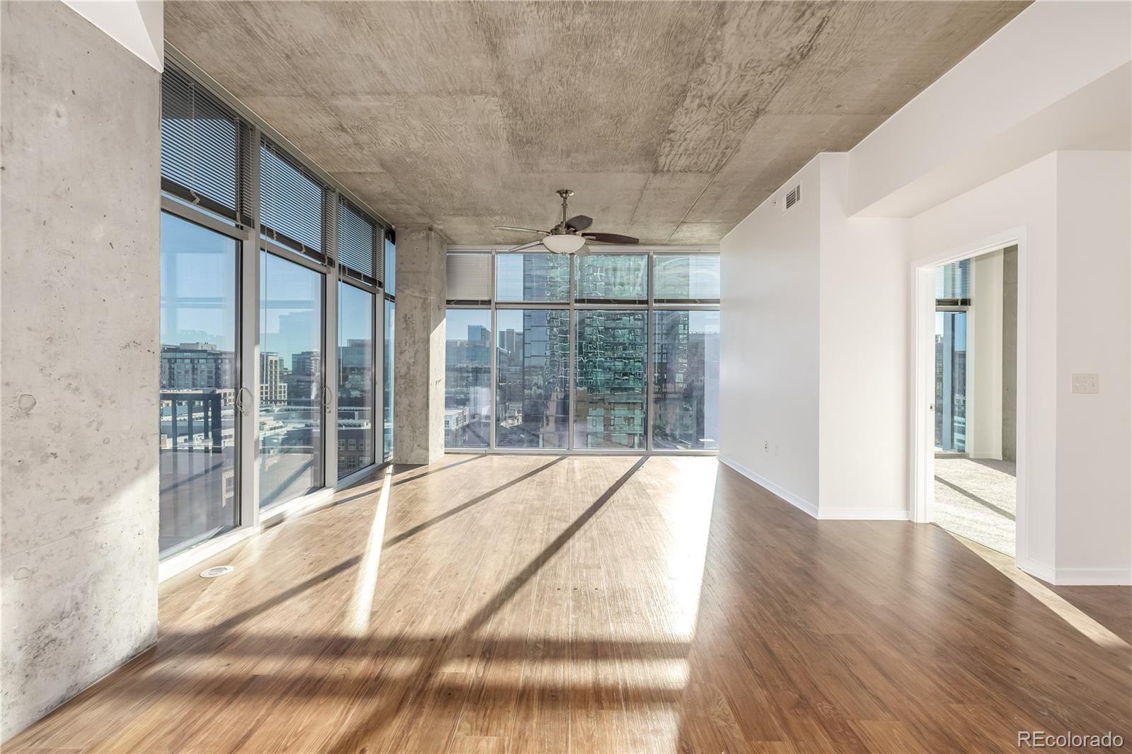 1700 Bassett Street, Unit 1012 Denver, CO 80202 - Photo 31 of 48 a view of an empty room with wooden floor and a window