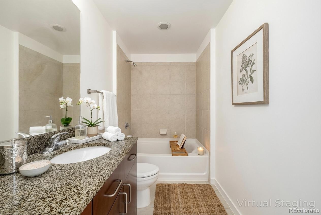 1700 Bassett Street, Unit 1012 Denver, CO 80202 - Photo 9 of 48 a bathroom with a granite countertop sink and a mirror