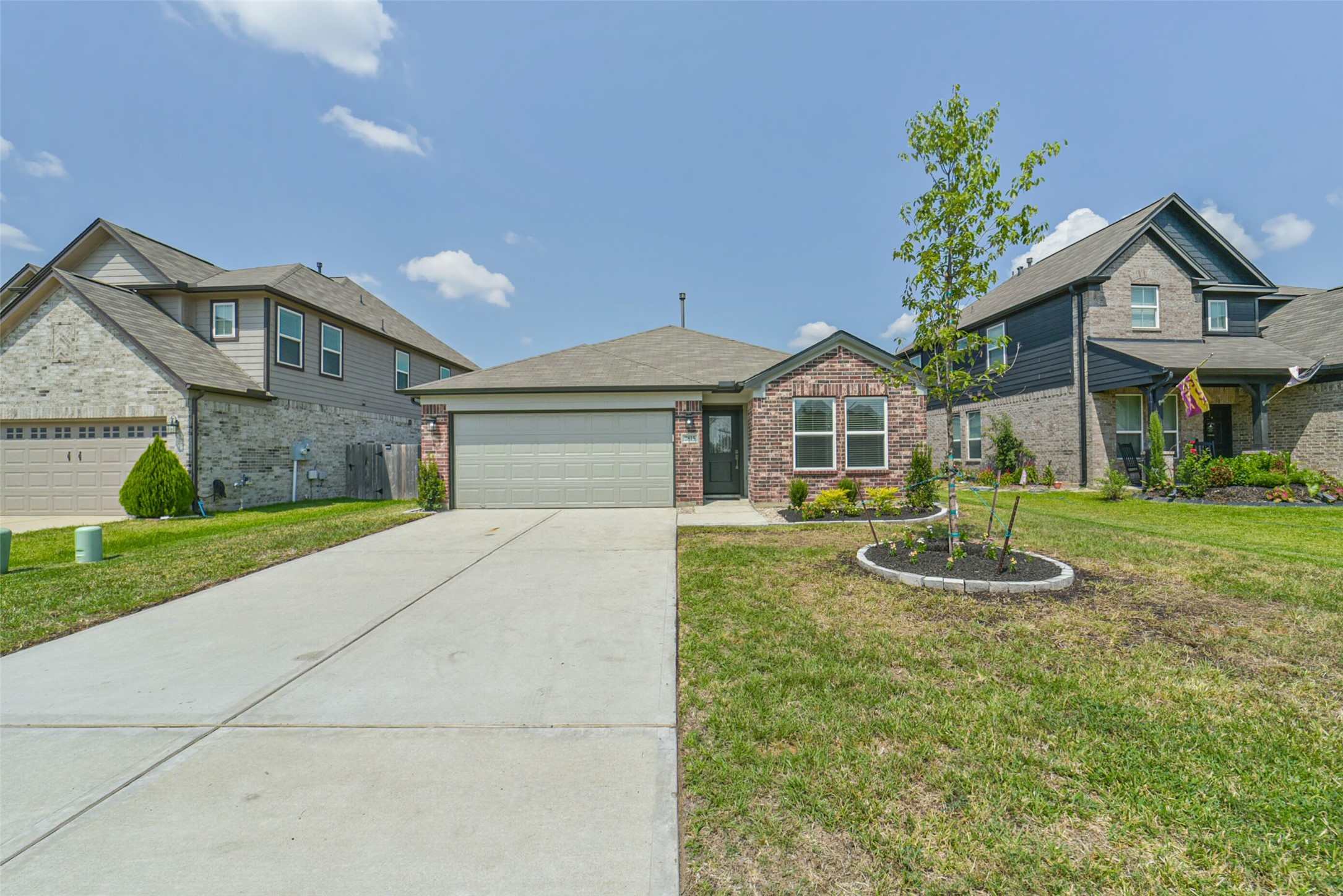 2815 Beech River Court Conroe, TX 77301 - Photo 2 of 34 a front view of a house with a yard and garage