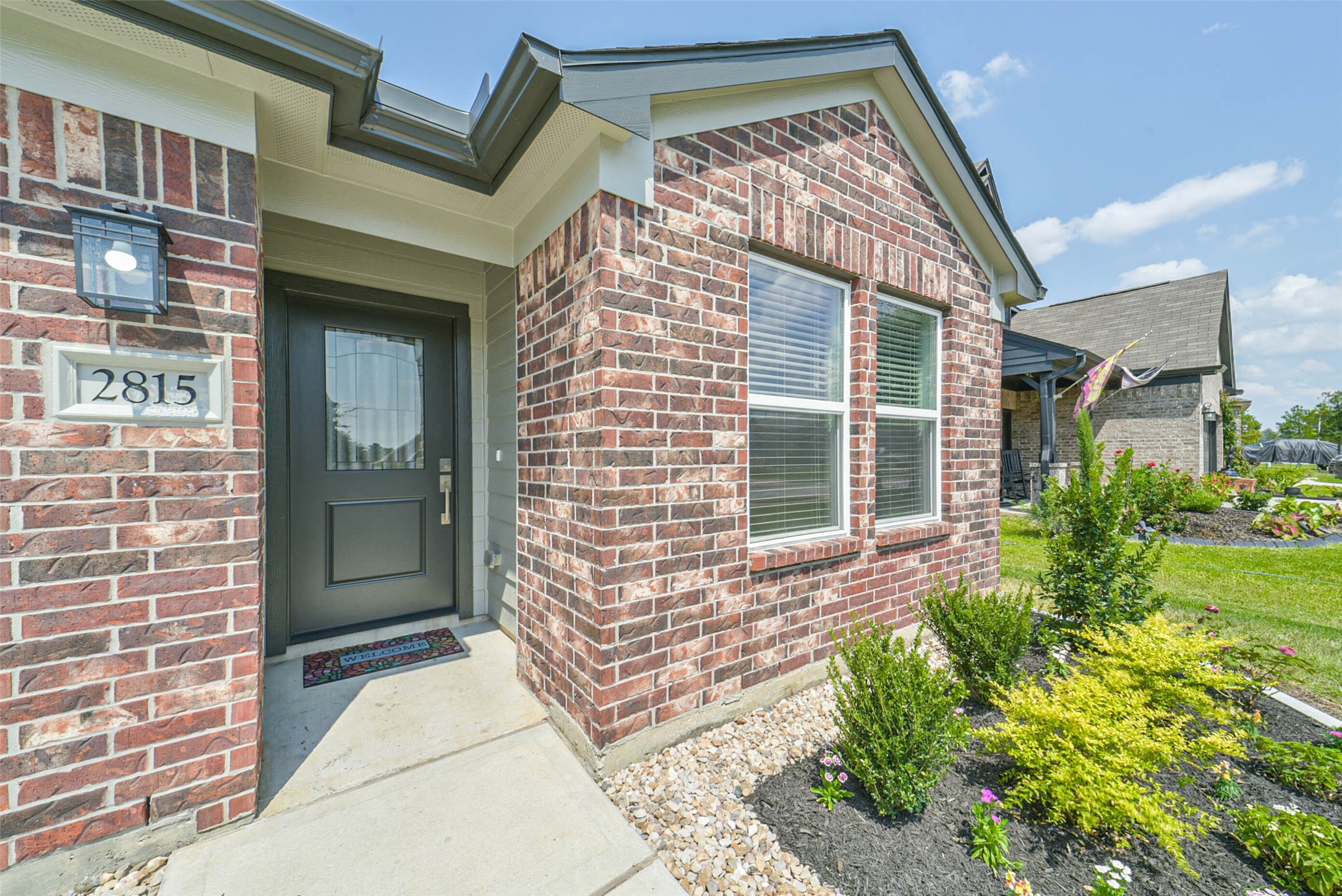 2815 Beech River Court Conroe, TX 77301 - Photo 5 of 34 a front view of a house with a garden