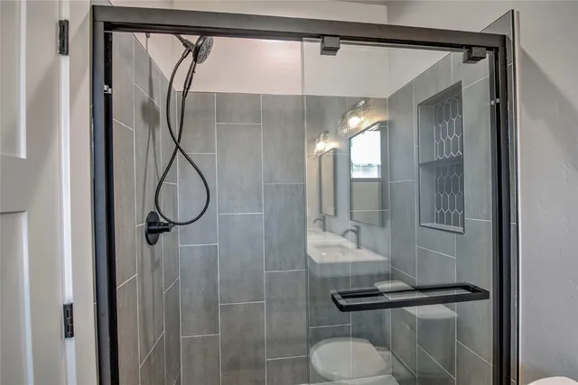 a bathroom with a shower and a mirror