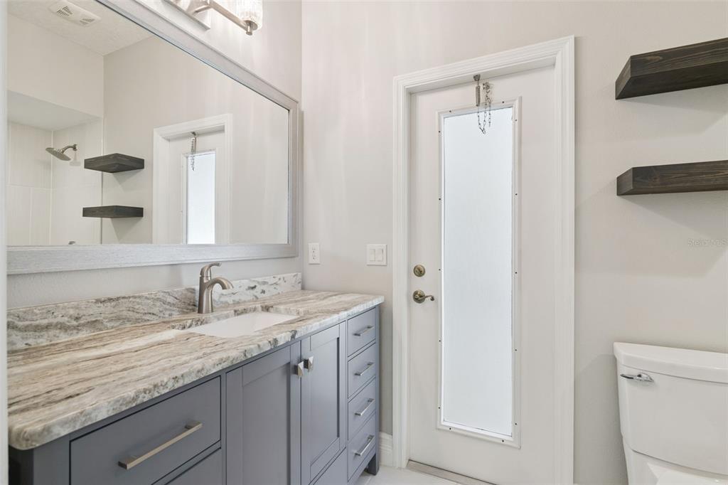 2230 Ridgewind Way Windermere, FL 34786 - Photo 25 of 38 a bathroom with a granite countertop sink and a mirror