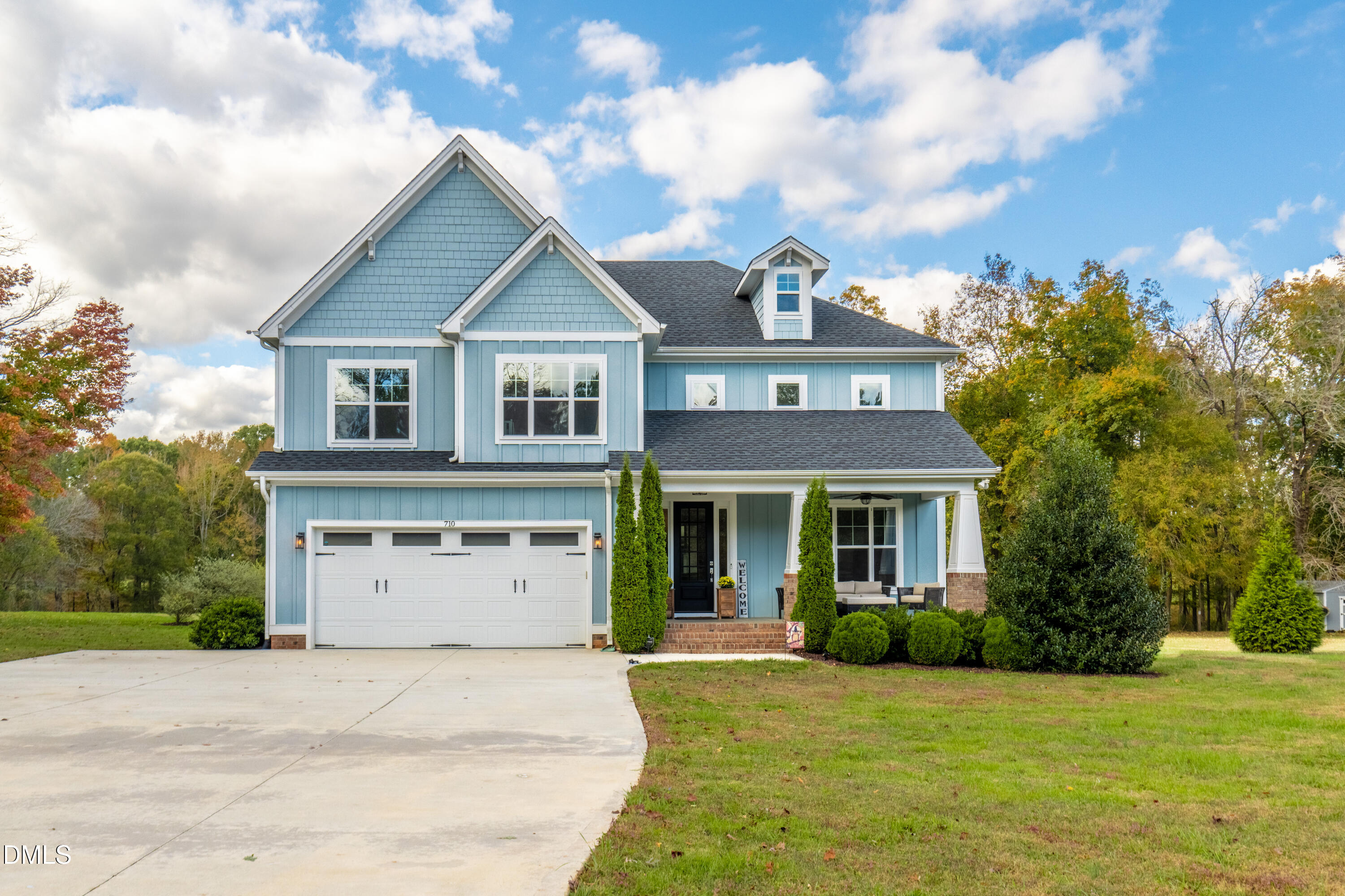 710 Hadley Mill Road Pittsboro, NC 27312 - Photo 1 of 56 a front view of a house with a yard and garage