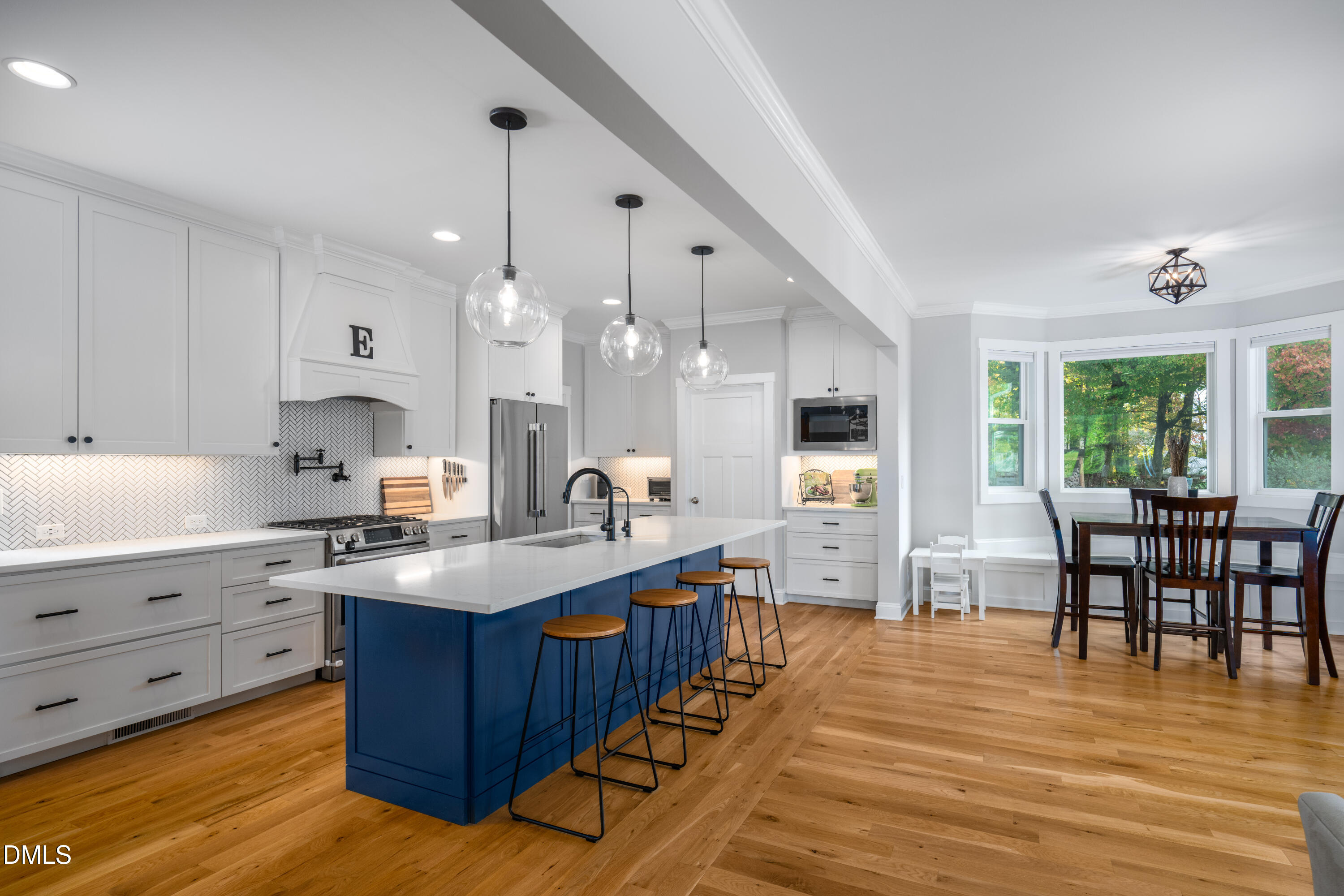 710 Hadley Mill Road Pittsboro, NC 27312 - Photo 4 of 56 a large kitchen with stainless steel appliances granite countertop a sink dishwasher a dining table and chairs with wooden floor