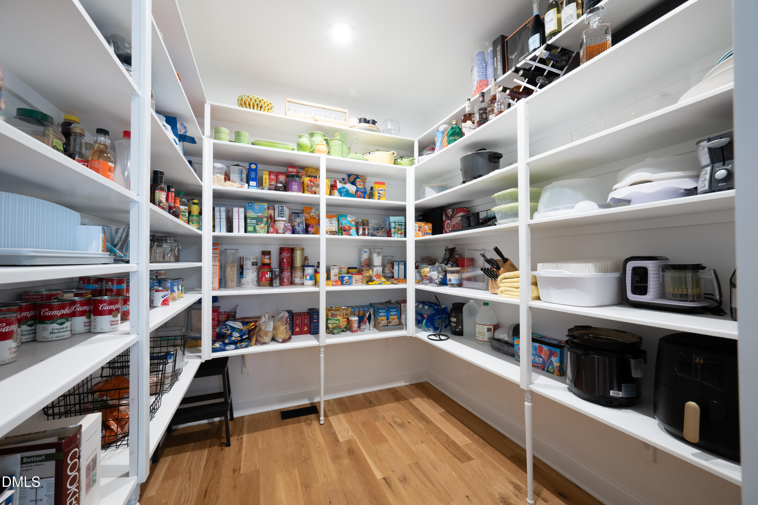 710 Hadley Mill Road Pittsboro, NC 27312 - Photo 7 of 56 a kitchen with stainless steel appliances cabinets and a wooden floor