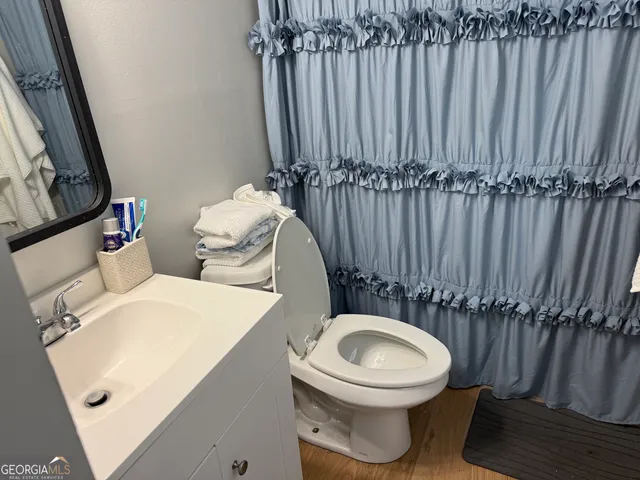 a bathroom with a toilet a sink and a mirror