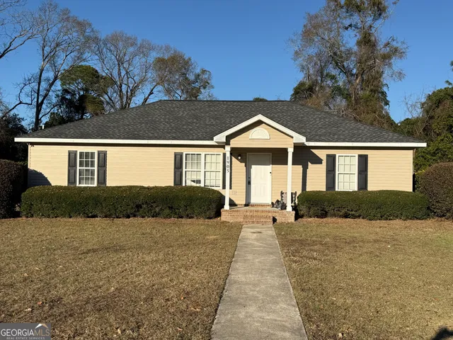a front view of a house with a yard