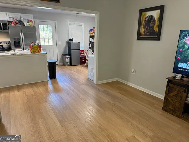 a view of a workspace with wooden floor and furniture