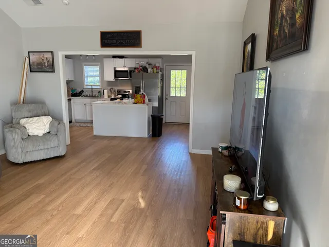 a living room with furniture and a flat screen tv