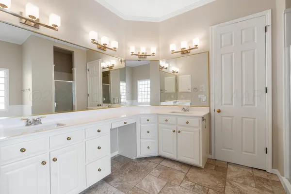 a spacious bathroom with a granite countertop sink mirror and a