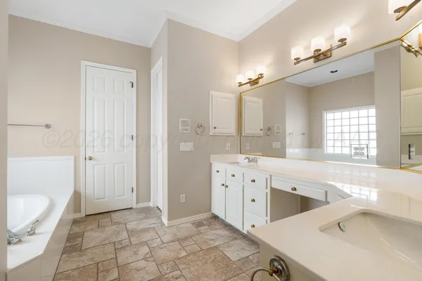a spacious bathroom with a sink mirror vanity and a bathtub