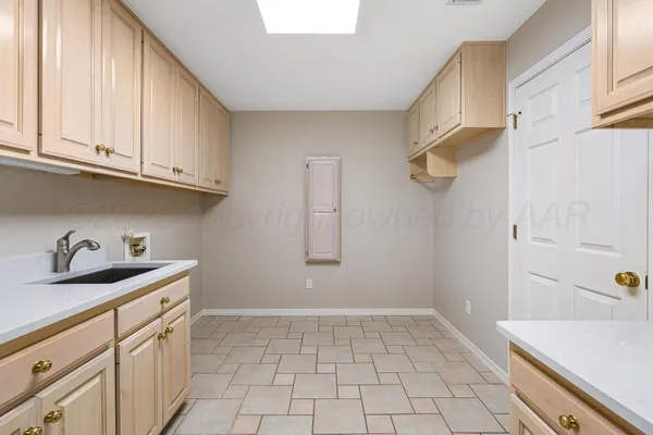a kitchen with white cabinets and a sink