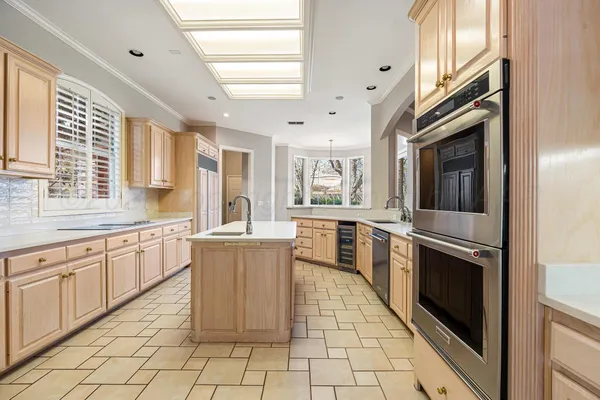 a kitchen with stainless steel appliances granite countertop a refrigerator and a stove top oven