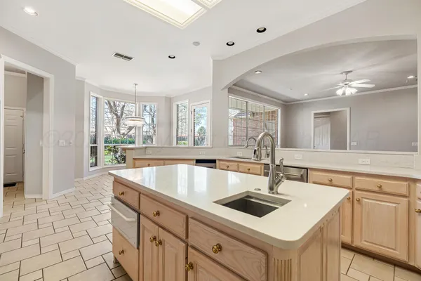 a kitchen with sink cabinets and window