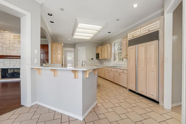 a kitchen with stainless steel appliances granite countertop a refrigerator and a sink